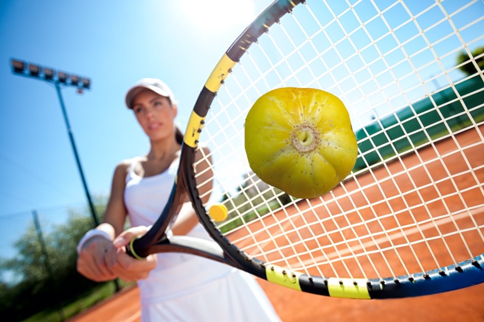 Mujer golpea un pepino de limón con una raqueta de tenis.